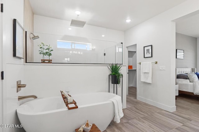 bathroom featuring shower with separate bathtub