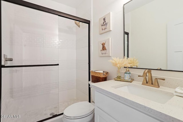 bathroom with vanity, toilet, and walk in shower