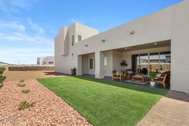 rear view of property with an outdoor hangout area and a yard
