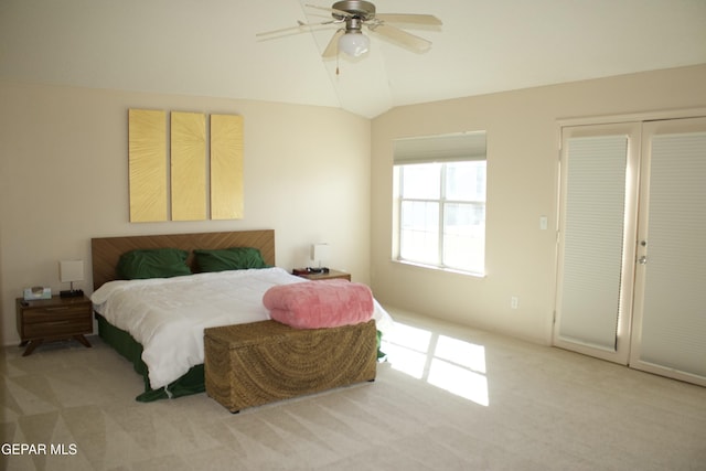 carpeted bedroom with ceiling fan and lofted ceiling