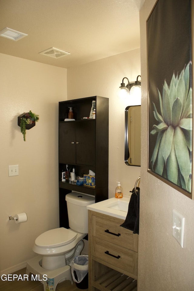 bathroom featuring vanity and toilet