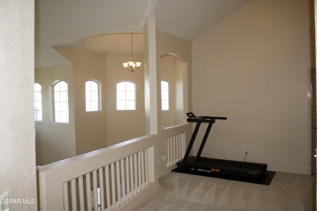 workout area with light carpet and a notable chandelier