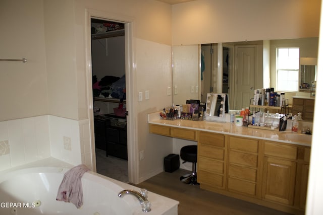 bathroom with sink, hardwood / wood-style floors, and a bathtub