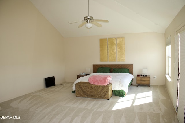 bedroom with vaulted ceiling, light colored carpet, and ceiling fan