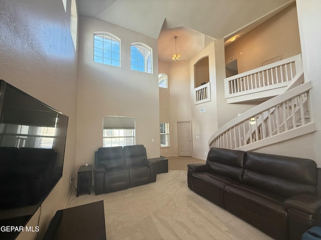 carpeted living room with a high ceiling