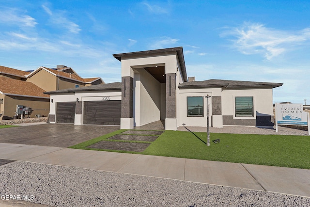 view of front of home featuring a garage and a front lawn