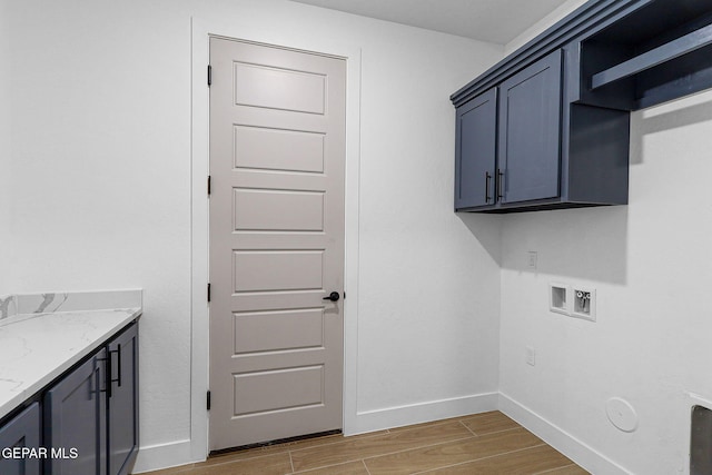 clothes washing area featuring cabinets, washer hookup, and hookup for a gas dryer