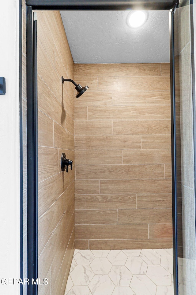 bathroom with tiled shower