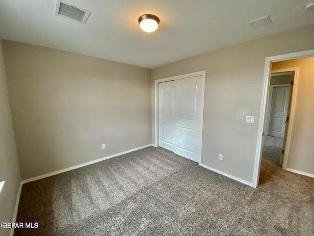 unfurnished bedroom featuring a closet and carpet flooring