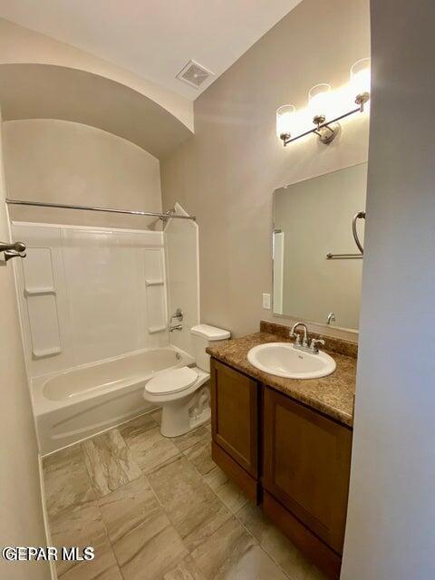 full bathroom featuring toilet, vanity, and shower / bathtub combination