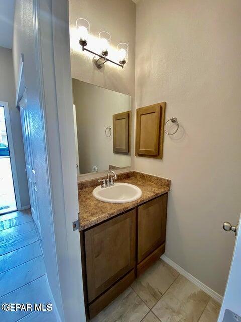 bathroom featuring tile patterned flooring and vanity