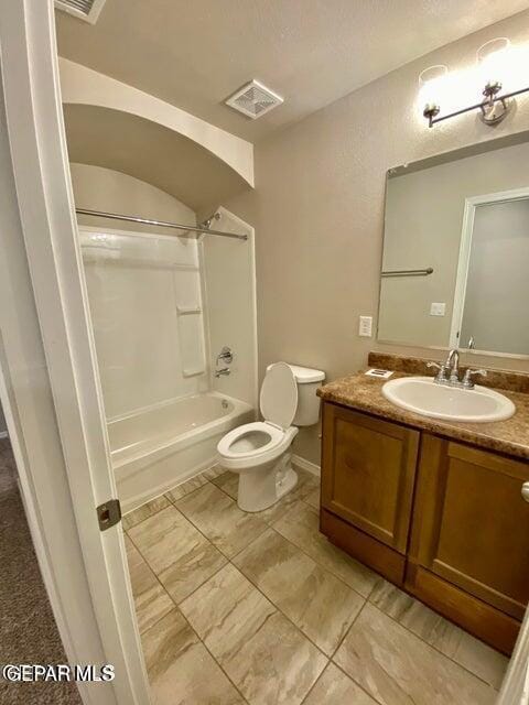 full bathroom featuring toilet, vanity, and  shower combination