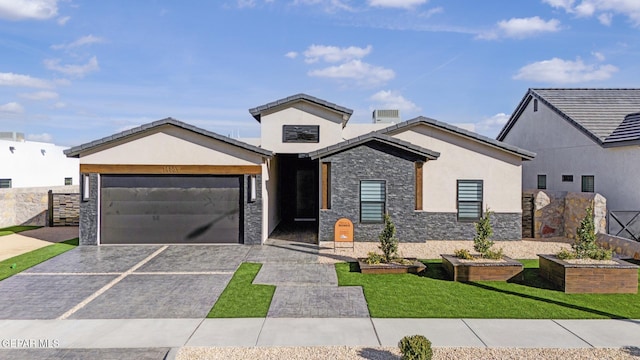 view of front of home featuring a garage and a front lawn