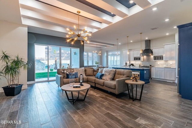 living room featuring dark hardwood / wood-style flooring and an inviting chandelier