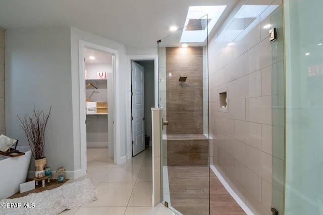 bathroom with a skylight and tile patterned floors