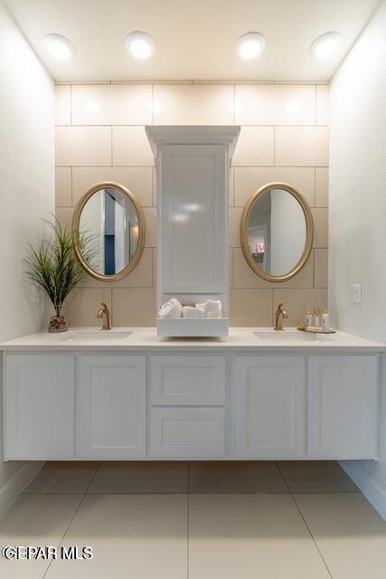 bathroom with tile patterned floors and vanity