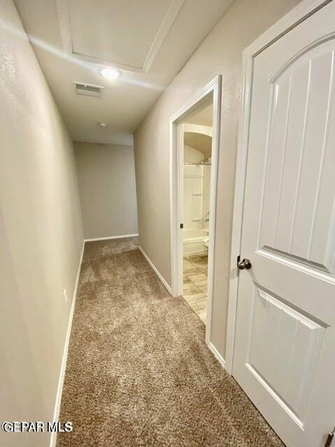 hallway with light colored carpet