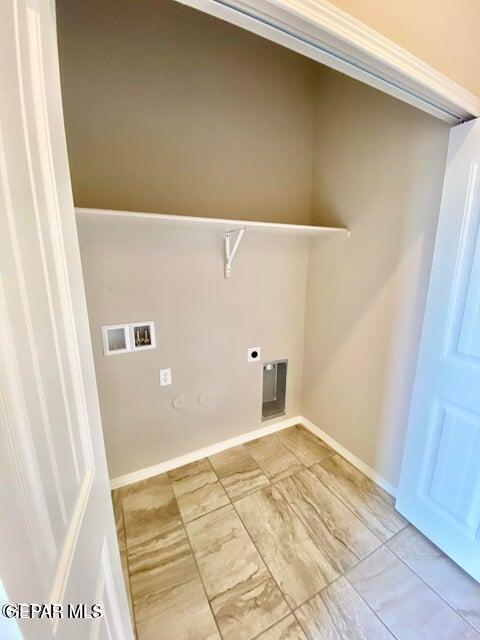 clothes washing area featuring washer hookup, hookup for an electric dryer, and hookup for a gas dryer