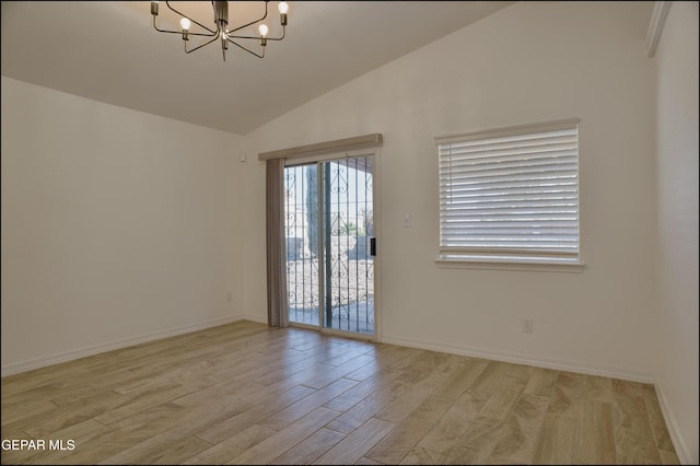 empty room with lofted ceiling, light wood-type flooring, and a notable chandelier