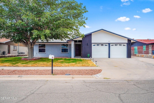 ranch-style home with a front lawn and a garage