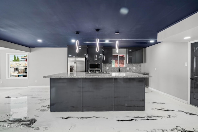 kitchen with a center island, light stone counters, tasteful backsplash, hanging light fixtures, and stainless steel fridge with ice dispenser