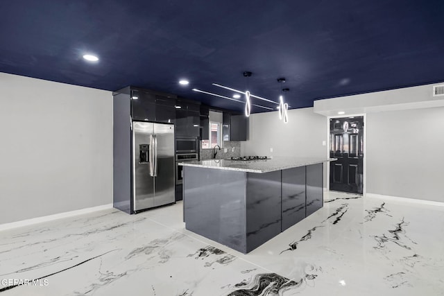 kitchen featuring light stone countertops, a center island, decorative light fixtures, stainless steel appliances, and sink