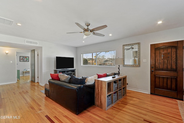 living room with light wood-type flooring and ceiling fan