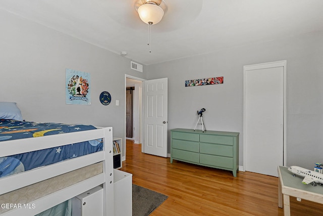 bedroom with ceiling fan and light hardwood / wood-style flooring