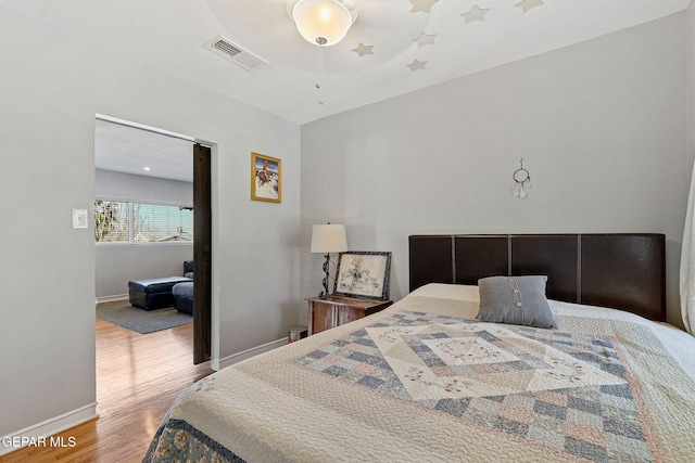 bedroom with ceiling fan and wood-type flooring