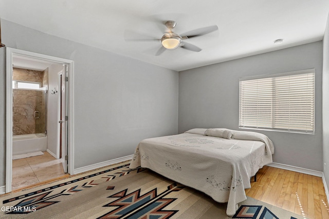 bedroom featuring ensuite bathroom, ceiling fan, and light wood-type flooring