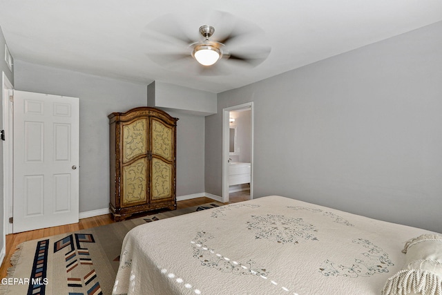 bedroom featuring ensuite bathroom, dark hardwood / wood-style flooring, and ceiling fan