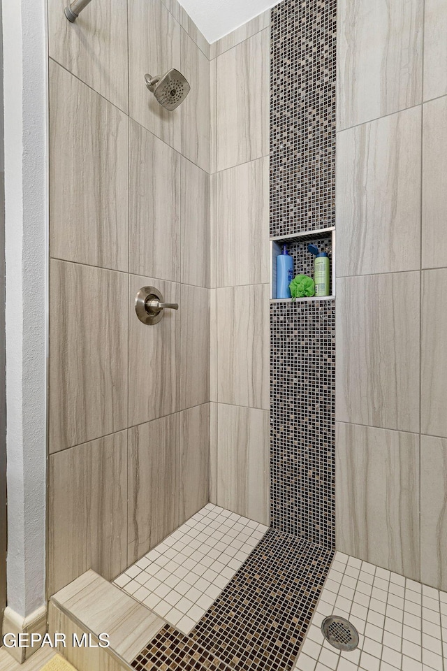 bathroom with a tile shower