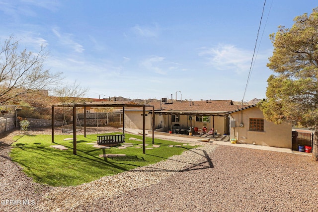 back of house with a lawn and a patio area