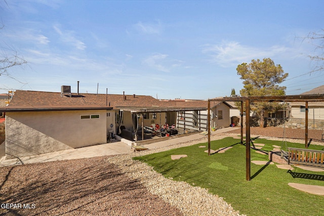 rear view of property with a lawn and a patio area