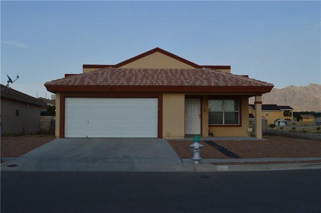 view of front of house featuring a garage and a mountain view