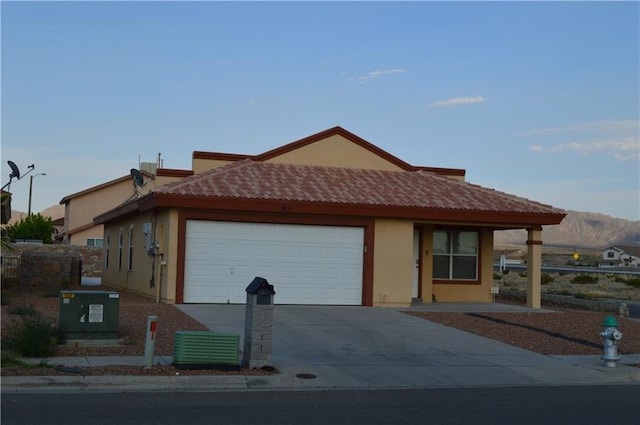 view of front of home with a garage and central AC unit