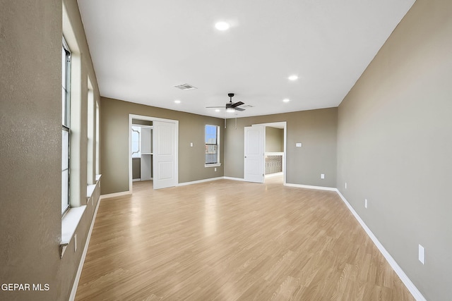 empty room with ceiling fan and light wood-type flooring