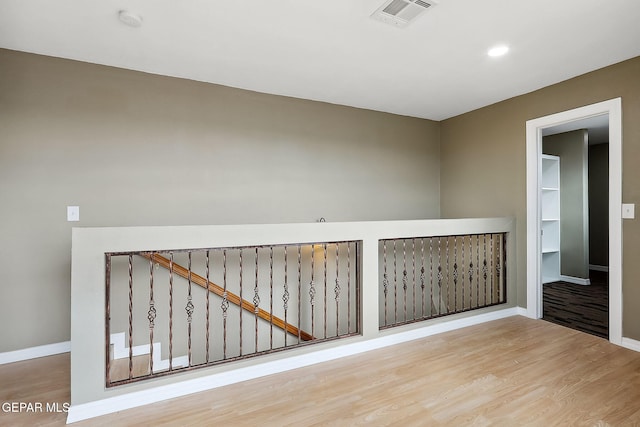 empty room with hardwood / wood-style flooring