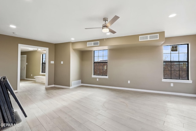 unfurnished room featuring light wood-type flooring and ceiling fan