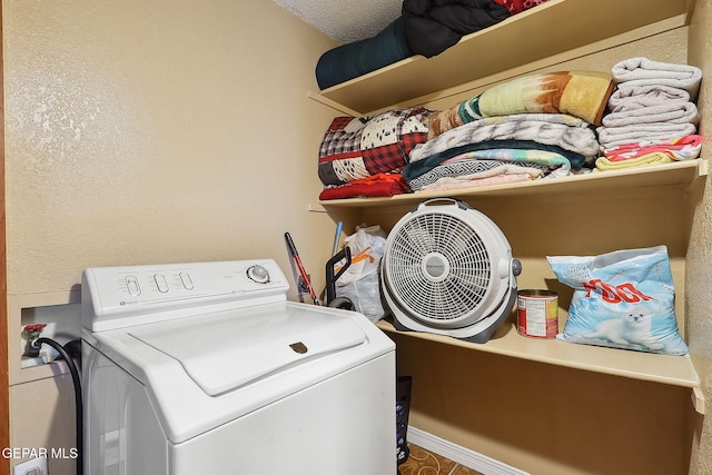 washroom with washer / dryer and a textured ceiling