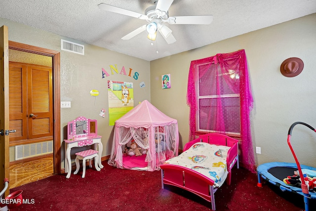 bedroom featuring ceiling fan, a textured ceiling, and carpet flooring