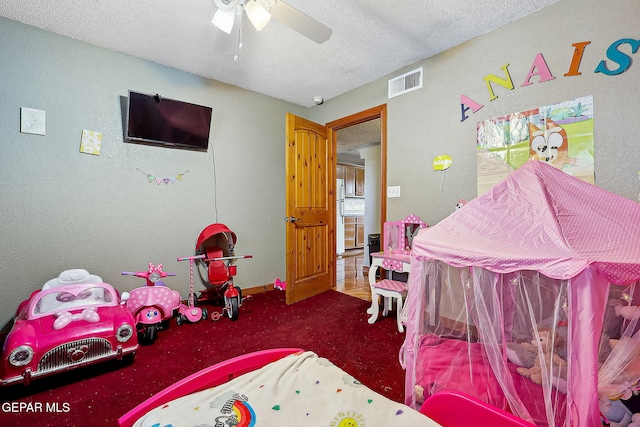 carpeted bedroom featuring a textured ceiling and ceiling fan