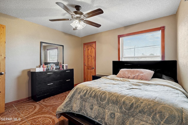 bedroom with a textured ceiling and ceiling fan