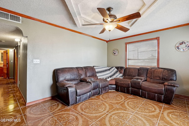 living room with ornamental molding, tile patterned flooring, ceiling fan, and a textured ceiling