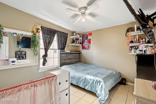 tiled bedroom featuring ceiling fan