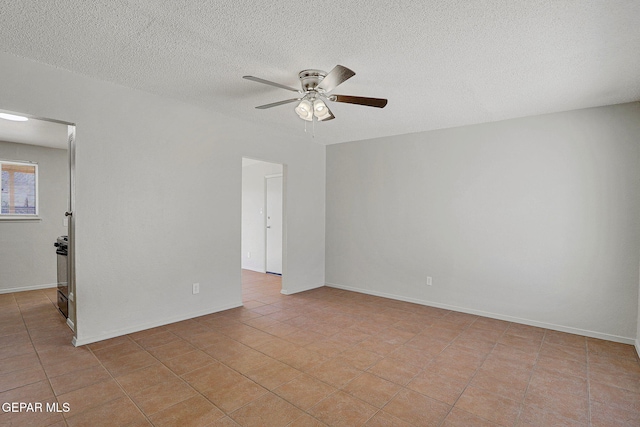 tiled spare room featuring ceiling fan and a textured ceiling