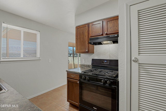 kitchen with gas stove, light tile patterned floors, and a healthy amount of sunlight