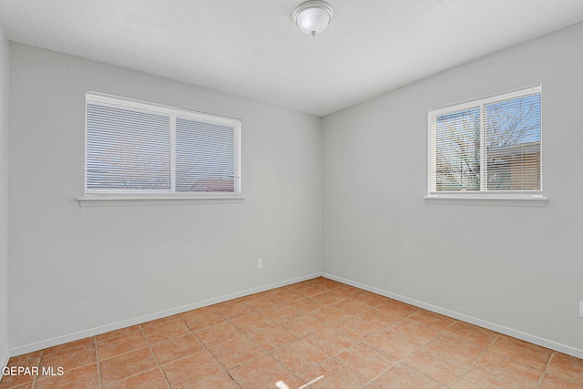 unfurnished room featuring light tile patterned floors