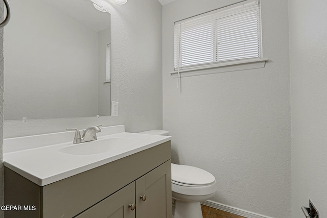 bathroom featuring toilet and vanity