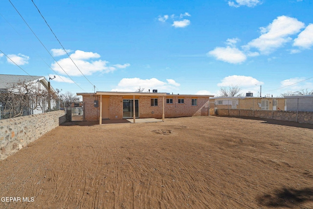 back of house featuring a patio and a yard